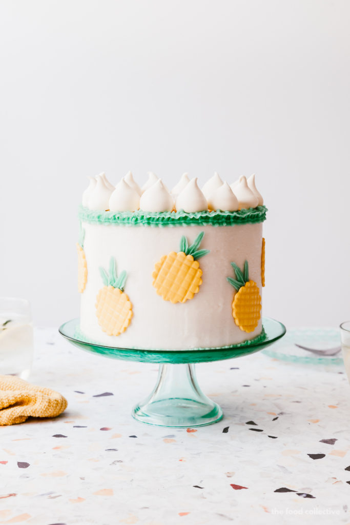 Perfectly moist and fluffy coconut layer cake filled with easy pineapple jam and creamy coconut buttercream frosting! #cake #coconutcake #pineapple #cakerecipe