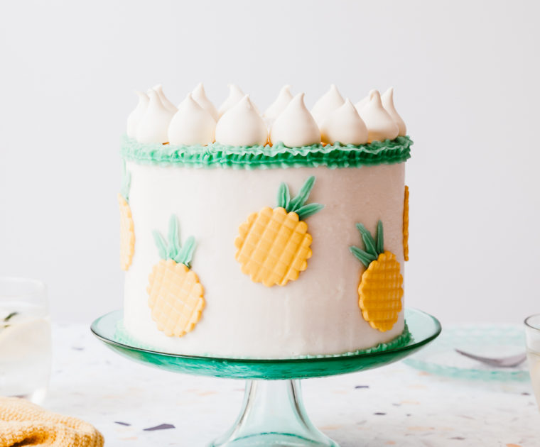 Perfectly moist and fluffy coconut layer cake filled with easy pineapple jam and creamy coconut buttercream frosting! #cake #coconutcake #pineapple #cakerecipe